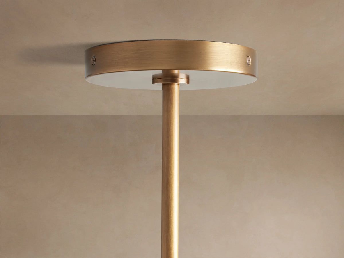 Close-up of Mandoza Chandelier: numerous clear, hand-blown glass globes with bubbly texture, warm light, burnished brass frame.