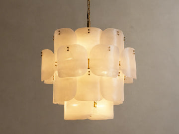 Blaire Round Chandelier. Multi-tiered, round chandelier with textured, pearlescent white molten glass panels glowing softly. Brass chain.
