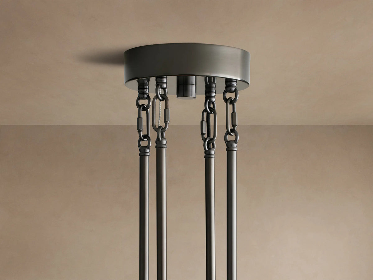 Delsie Round Chandelier, close-up of layered clear fluted glass rods & dark bronze metal frame, reflecting light.