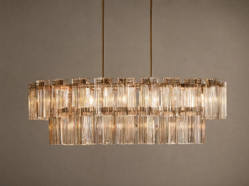 Delsie Oval Tiered Chandelier, burnished brass finish, two tiers of illuminated fluted glass rods on a simple background.