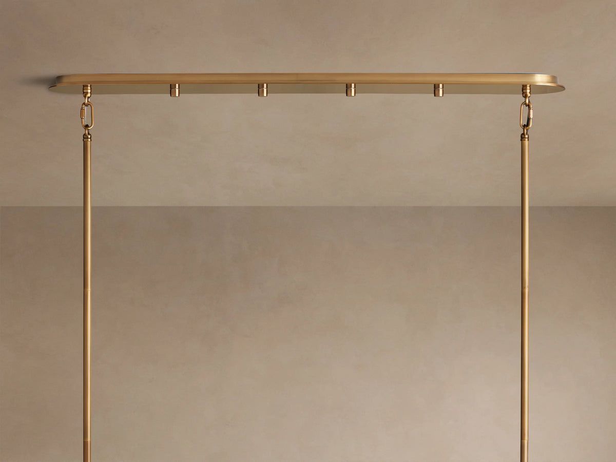 Delsie Oval Tiered Chandelier, burnished brass finish, two tiers of illuminated fluted glass rods on a simple background.