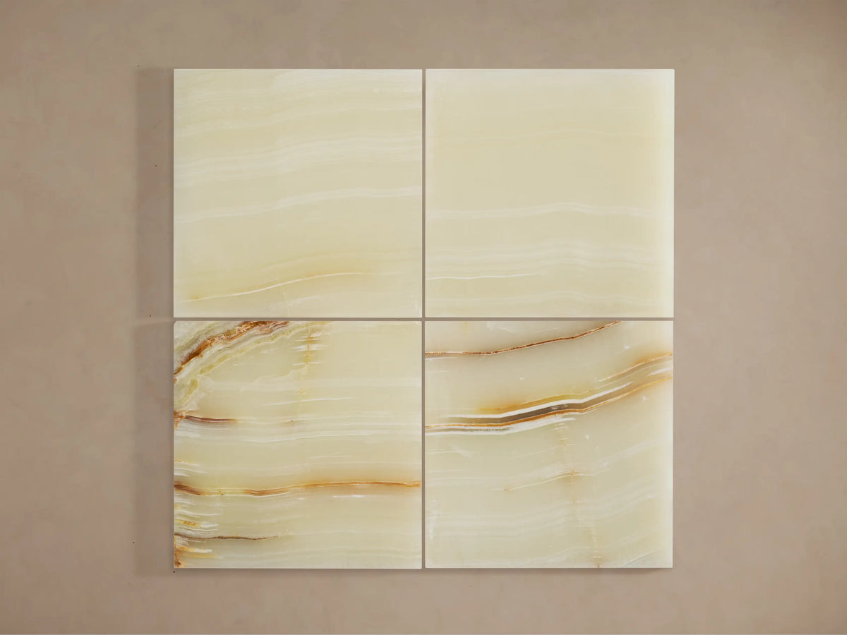 Four square alabaster tiles, showing natural cream, yellow, and brown veining, for Emerie Table Lamp shade.