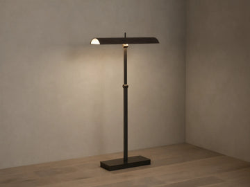 Abel Leather Floor Lamp: dark bronze finish, horizontal leather shade emitting warm LED light, stands on a wood floor.