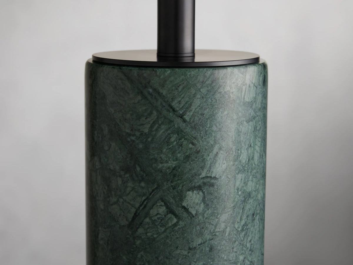 Brixton Table Lamp with a green marble cylindrical base, topped with a large off-white drum shade, on a wooden surface.
