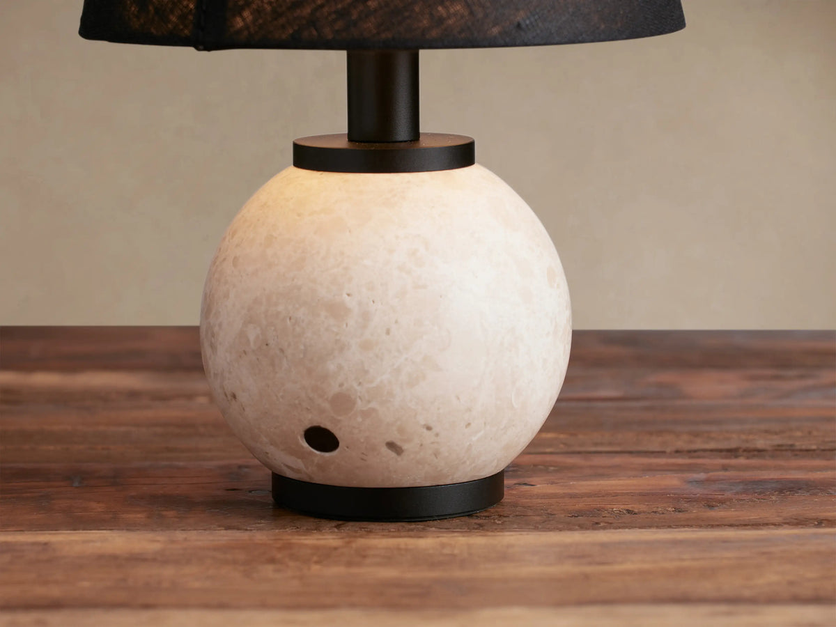 Celia Outdoor Rechargeable Lamp: cream marble spherical base, black linen tapered shade, matte black accents on wood.