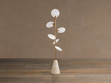 Lyla Floor Lamp: conical travertine base, golden stem with six glowing leaf-shaped white glass diffusers spirally.