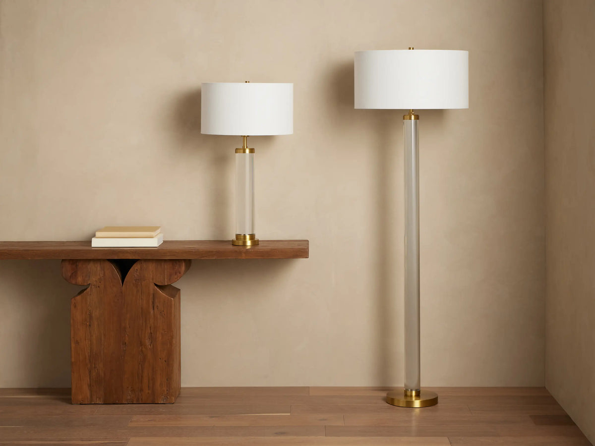 Illuminated Linden Crystal Floor Lamp: tall clear crystal column, brass accents, and white linen drum shade on a wooden floor.