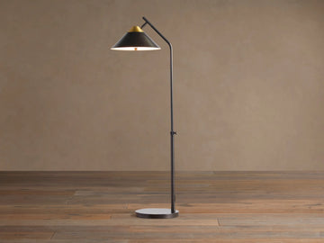 Marquee Bronze Task Floor Lamp. Dark bronze iron frame, conical shade with brass accent, adjustable pole, round base. Light on.