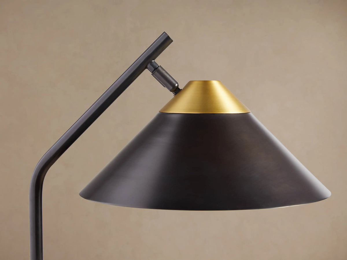 Marquee Bronze Task Floor Lamp with a dark bronze adjustable pole, dark conical shade with a brass top, and round base.