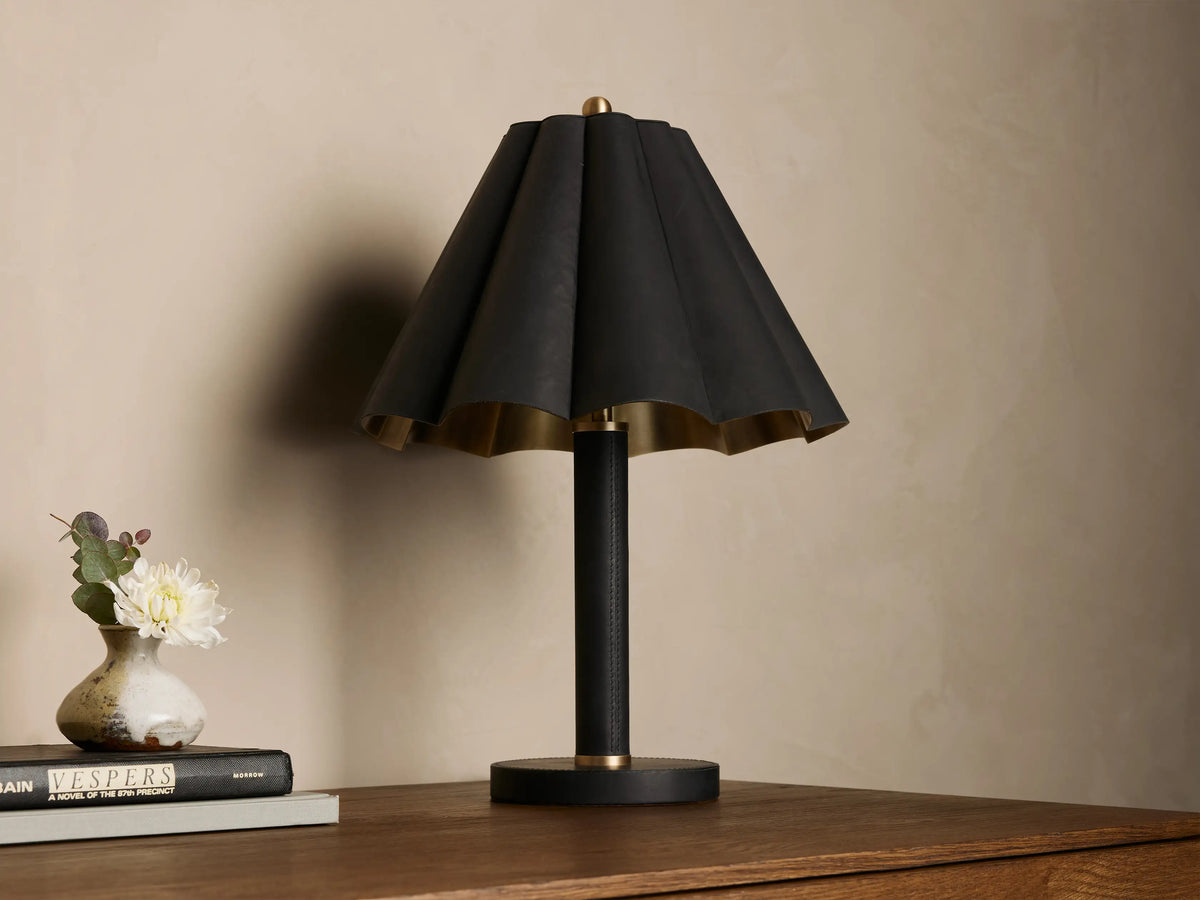 Lucy Accent Table Lamp, black pleated leather shade with gold interior, black leather-wrapped stem, and brass accents on wood.