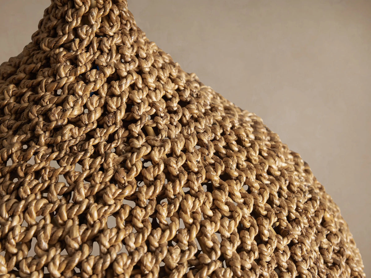 Canela 15" Pendant, bell-shaped, handwoven natural banana rope shade with textured weave, hanging from a black cord.