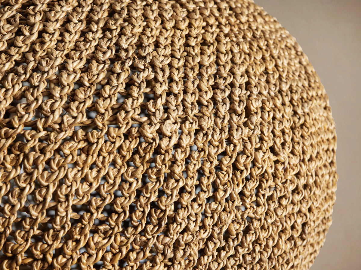 Canela 26" Pendant, a rounded natural banana rope handwoven light fixture with an open weave, hanging from a black cord.