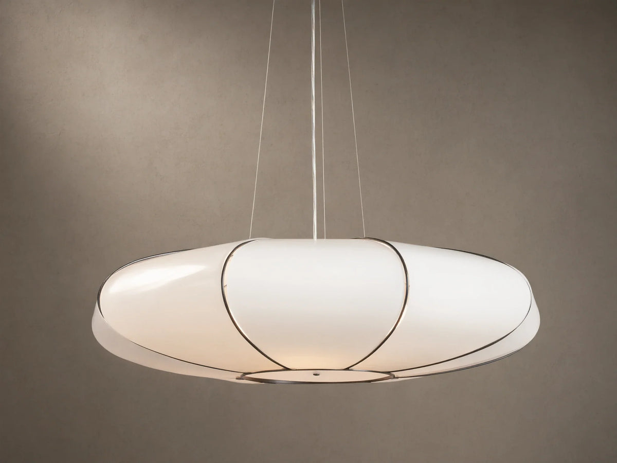 Nuvola Chandelier: elongated white milk glass oval pendant, bronze frame, softly glowing, hanging against a brown background.