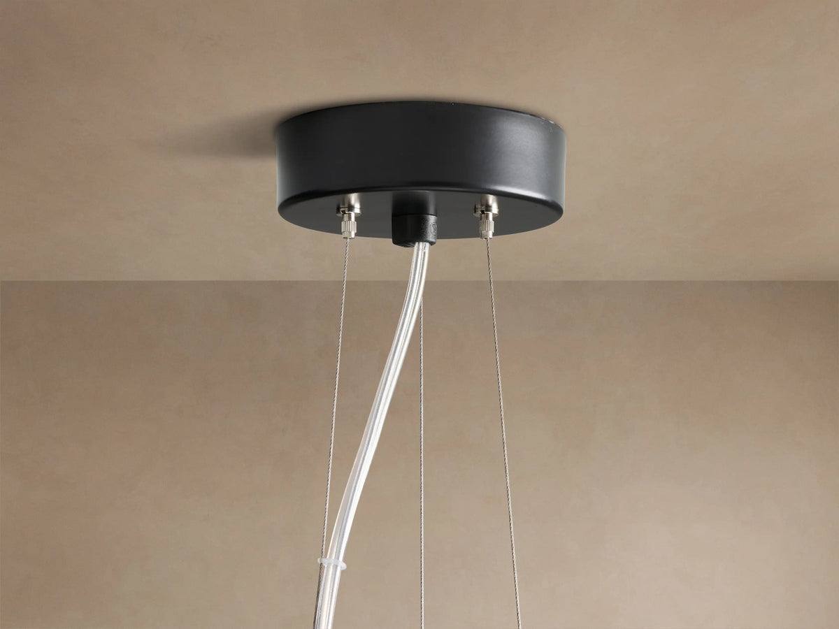 Nuvola Chandelier: bottom view of white, cloud-like milk glass panels framed by dark bronze, softly illuminated.