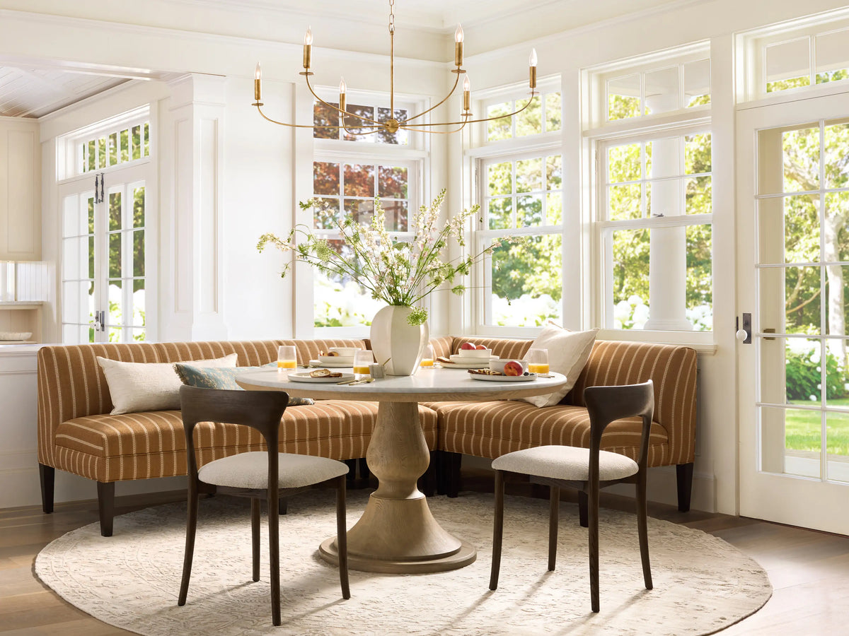 Arnett Chandelier, 6-light antique gold iron fixture with curved arms and candle-style bulbs, hanging from a chain.