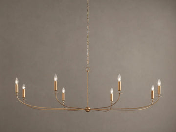 An Arnett Chandelier, an 8-light golden iron fixture with an antiqued leaf finish. Curved, elongated shape, suspended by chain.