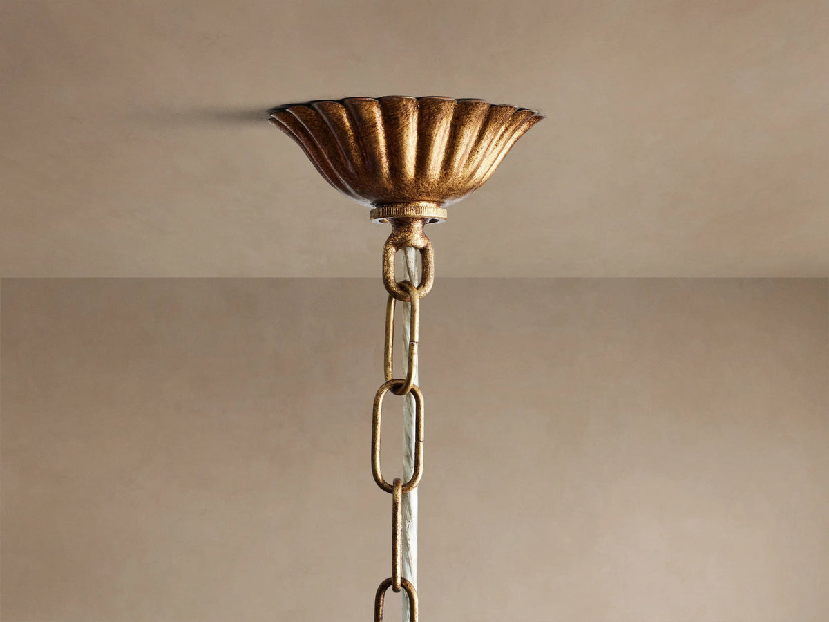 Close-up of Fritz Chandelier: intricate grid of hand-hammered, dark antique gold iron with two visible E12 bulbs on textured bases.