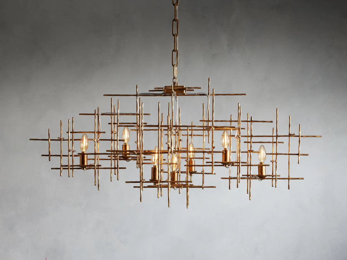 Close-up of Fritz Chandelier's fluted, dark antique gold canopy attached to a ceiling, with a thick chain and white cord extending down.