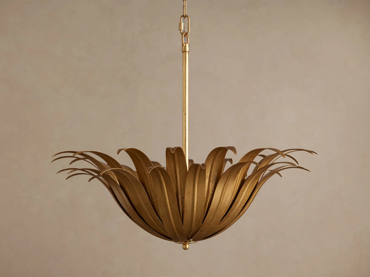Matilde Pendant: antique-gold iron fixture with curved, overlapping petals forming a flower-like bowl, hanging from a chain.