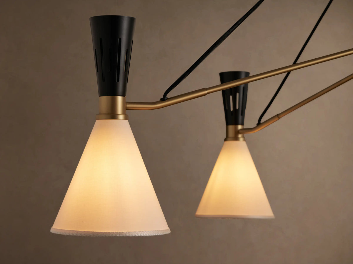 Ramsey Round Chandelier: five white fabric cone shades, matte black iron tops, satin brass frame, black suspension wires.