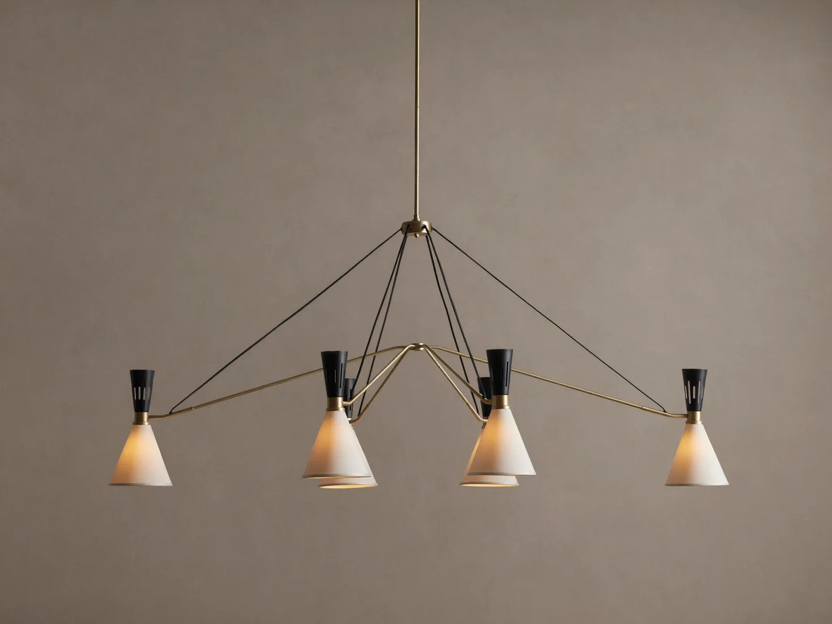 Ramsey Linear Chandelier with a satin brass frame, matte black accents, and six glowing white conical fabric shades.