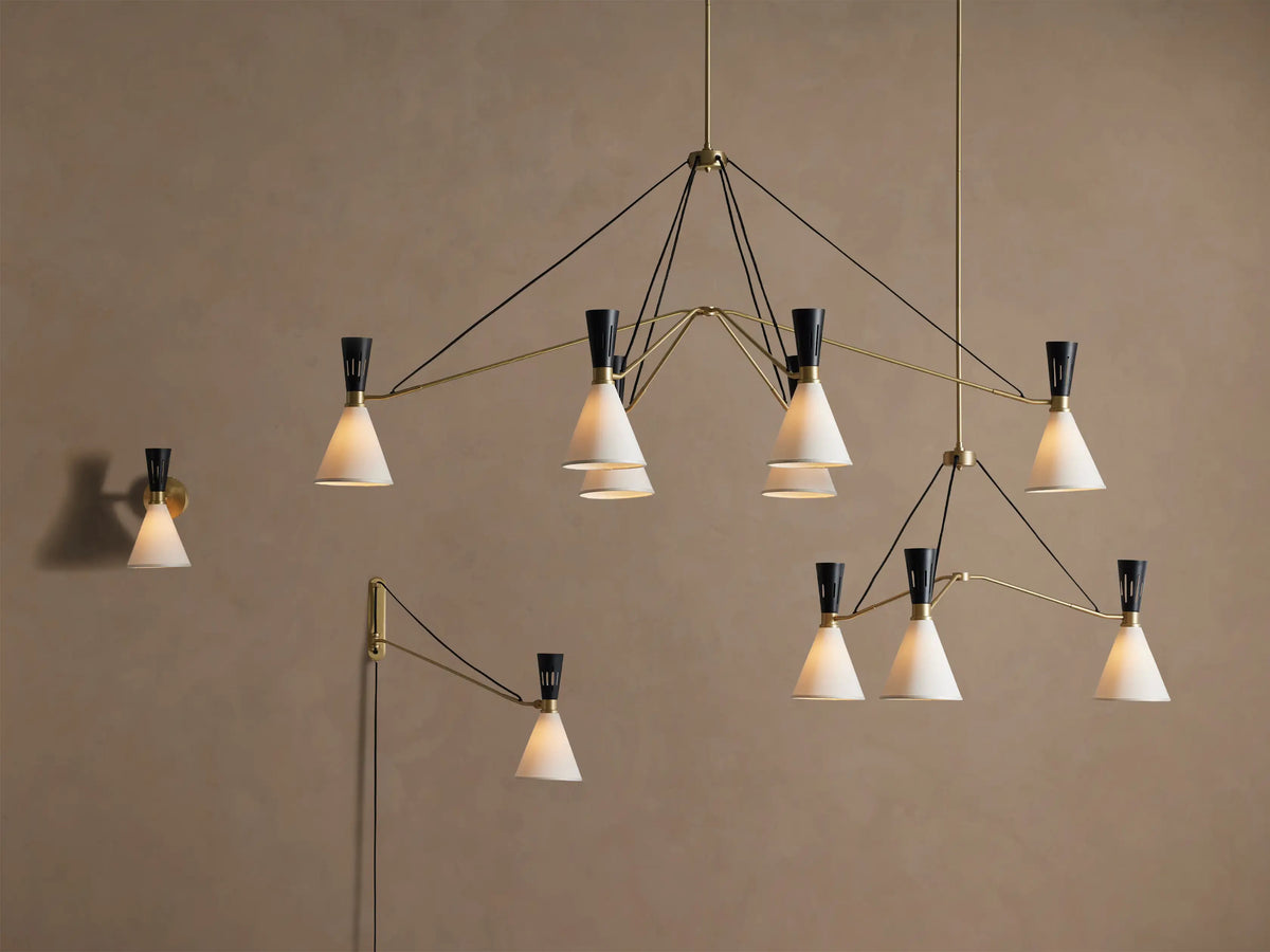 Close-up of Ramsey Linear Chandelier's satin brass canopy mounted on a light ceiling, with a brass downrod extending down.
