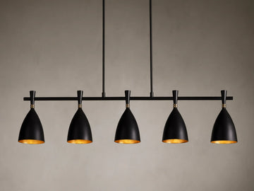 Jacarra Linear Chandelier with five black metal shades, gold leaf interior, hanging from an old bronze rod against a gray background.