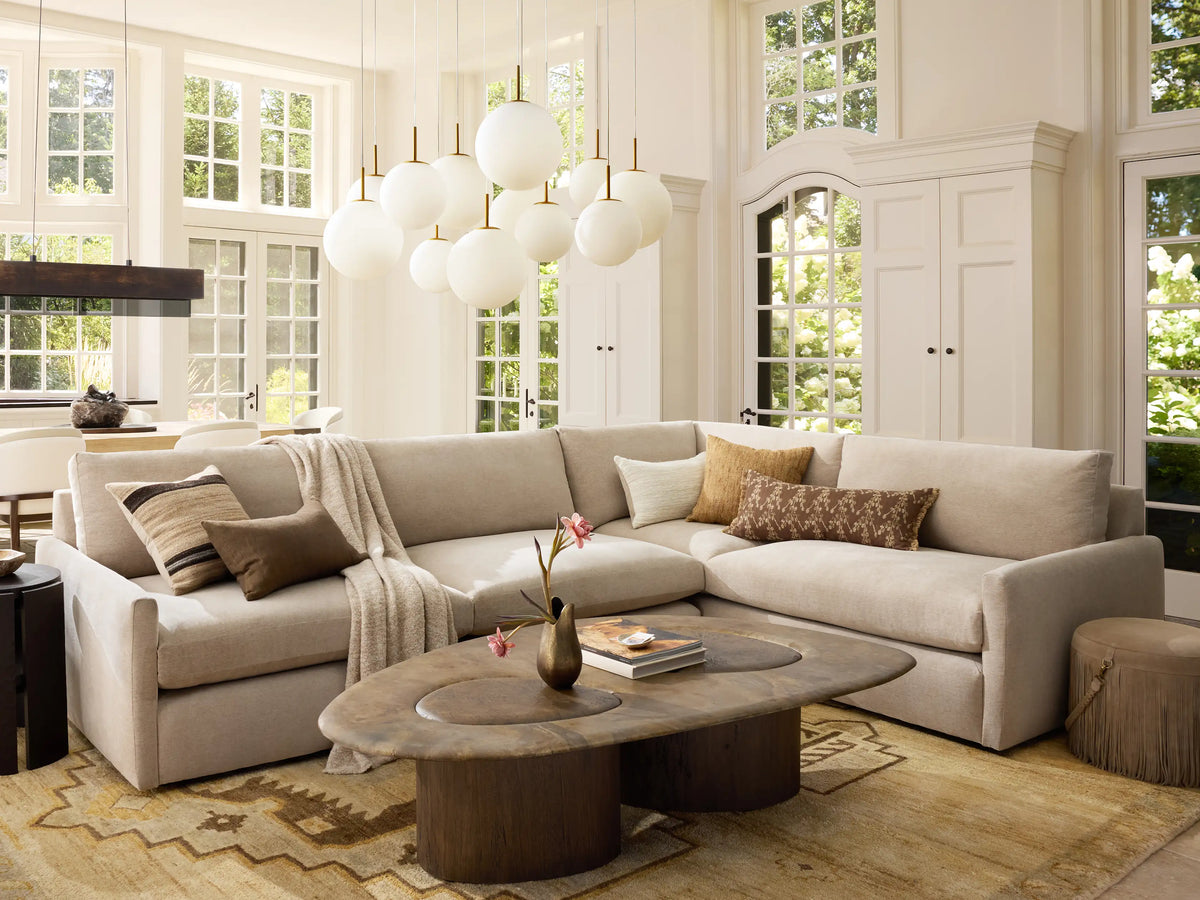 Casen Round Chandelier. Three illuminated crackle glass globes with satin brass accents, suspended at varying heights.