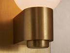 Casen Sconce: Satin brass rectangular wall plate with a cylindrical holder extending forward, supporting an opaque white glass globe.