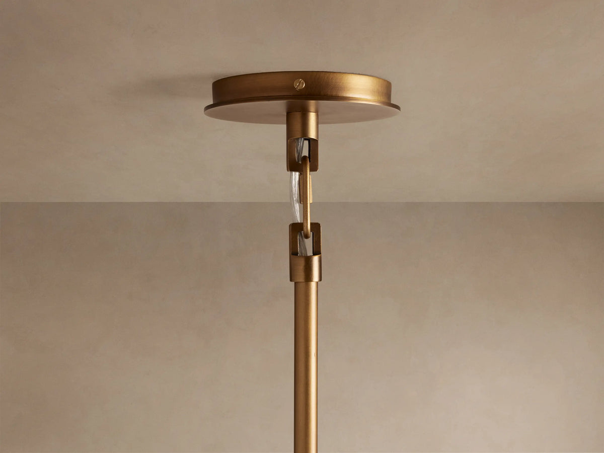 Adria 2-Light Chandelier, bronze-finished iron, illuminated cream conical shade with metal trim, seen close-up.