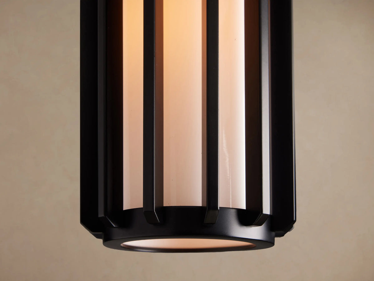 Gabbia Outdoor Spotlight Flush Mount, matte black with vertical slats, milk glass diffuser, mounted on a beige ceiling.