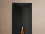 Davian Outdoor Sconce, a sleek black rectangular light with geometric angled front, mounted vertically on a light beige wall.
