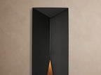 Davian Outdoor Sconce, dark bronze finish, geometric vertical form with angled cutouts, mounted on a light beige wall.