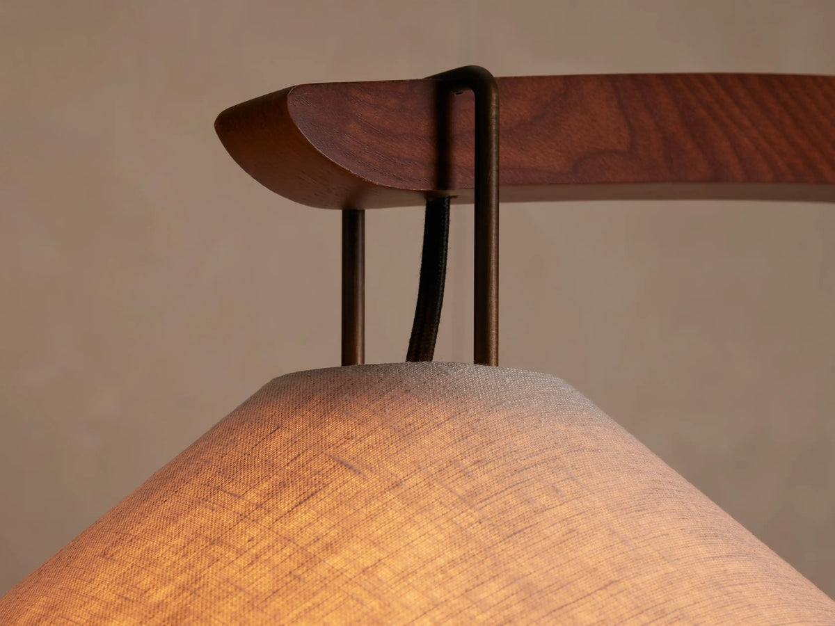 Monviso Floor Lamp with arc-shaped walnut wood frame, conical white fabric shade, and espresso brown stone base.