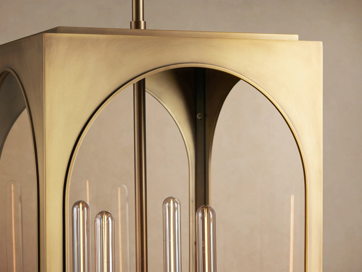 Palladian Outdoor Pendant: Rectangular brass lantern with arched glass windows, showcasing three clear tube bulbs, hanging.