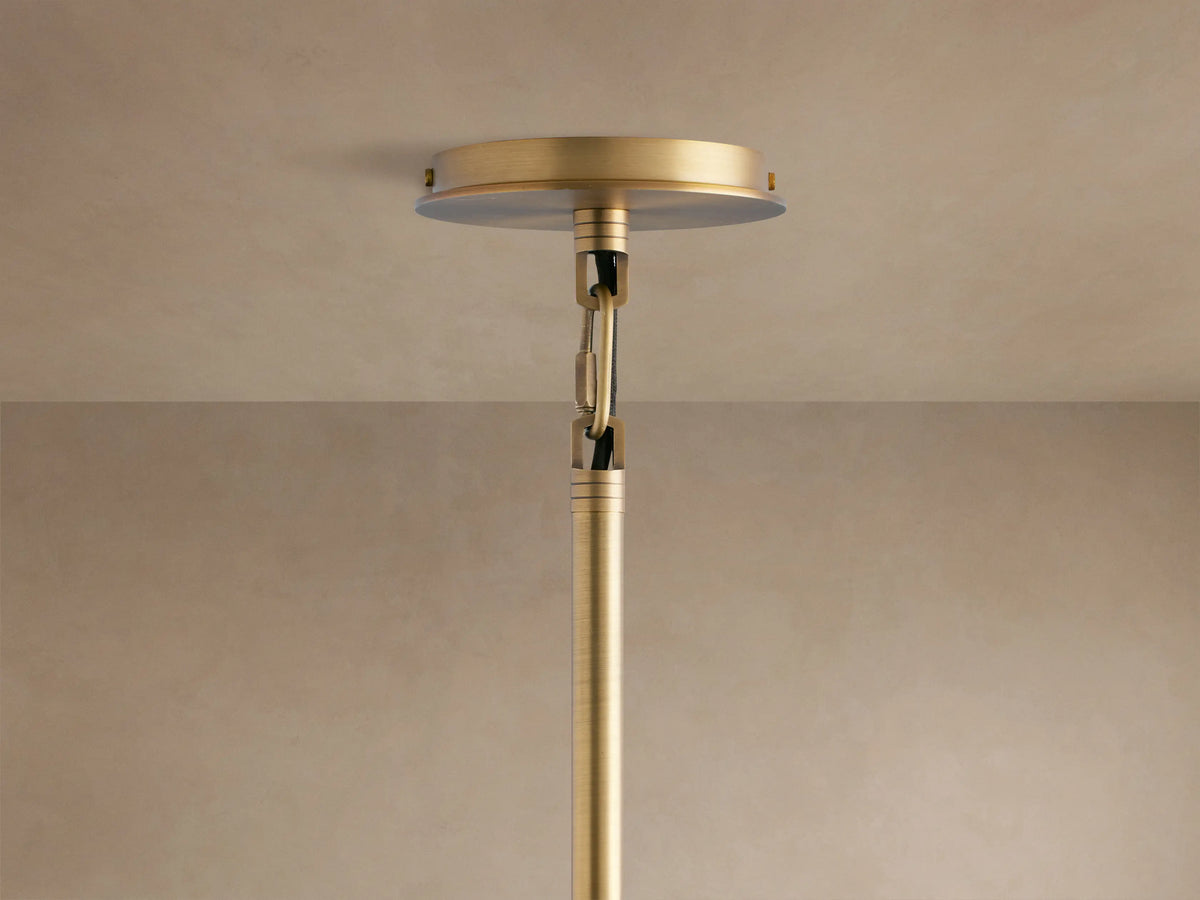 Antique brass Palladian Outdoor Pendant with arched glass panels and cylindrical bulbs, seen in a close-up view.