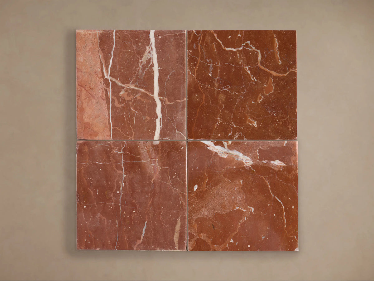 A close-up of a lamp with a ribbed, reddish-brown marble-like shade and base against a neutral wall, showcasing its textured surface.