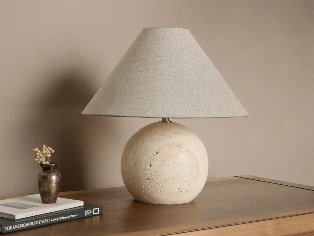 Front view of a Stone Sphere Table Lamp with a textured off-white spherical base and a tapered light grey fabric shade.