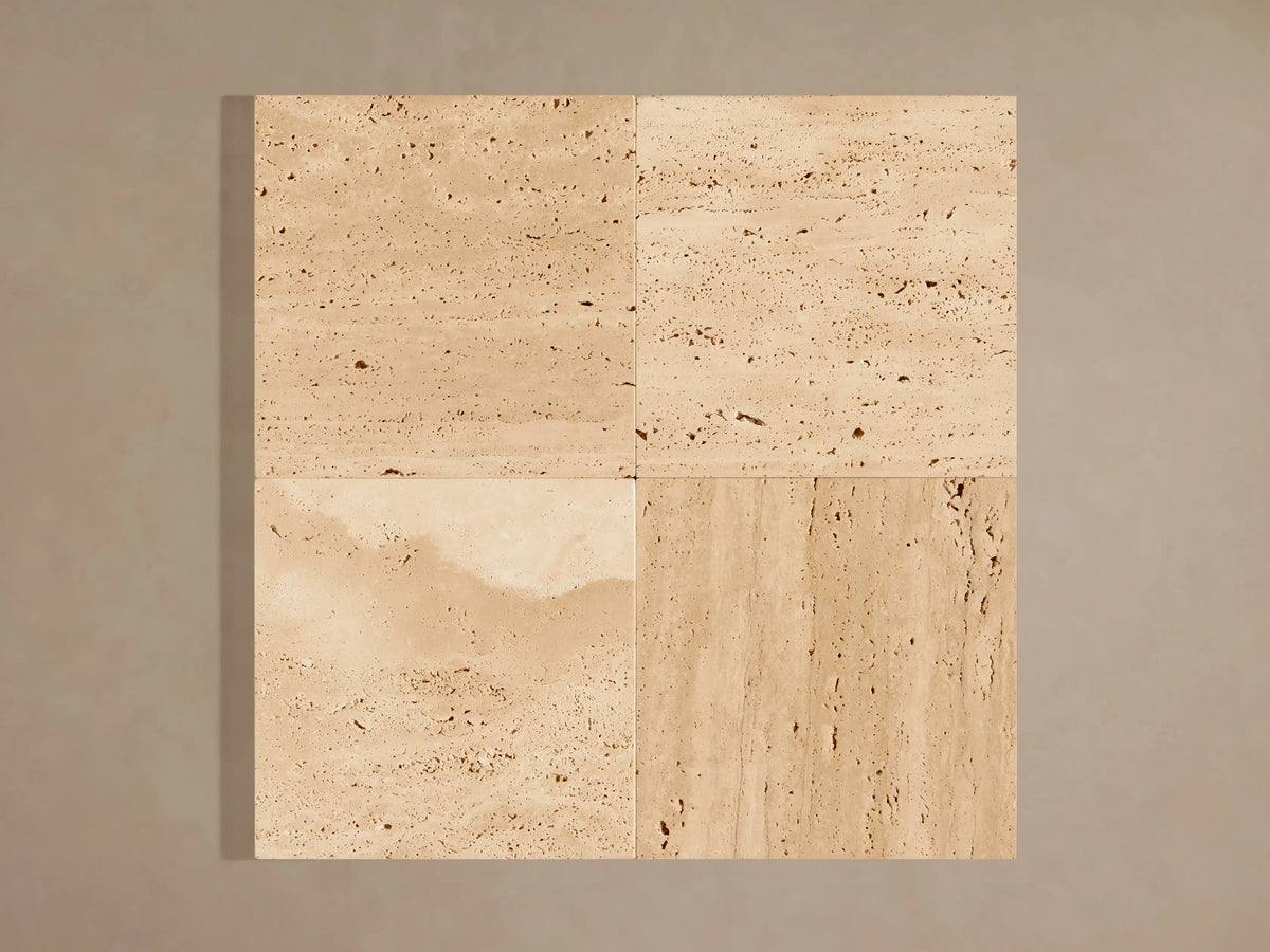 Natural beige stone Odette Outdoor Sconce, horizontally veined, illuminated from behind with a warm glow.