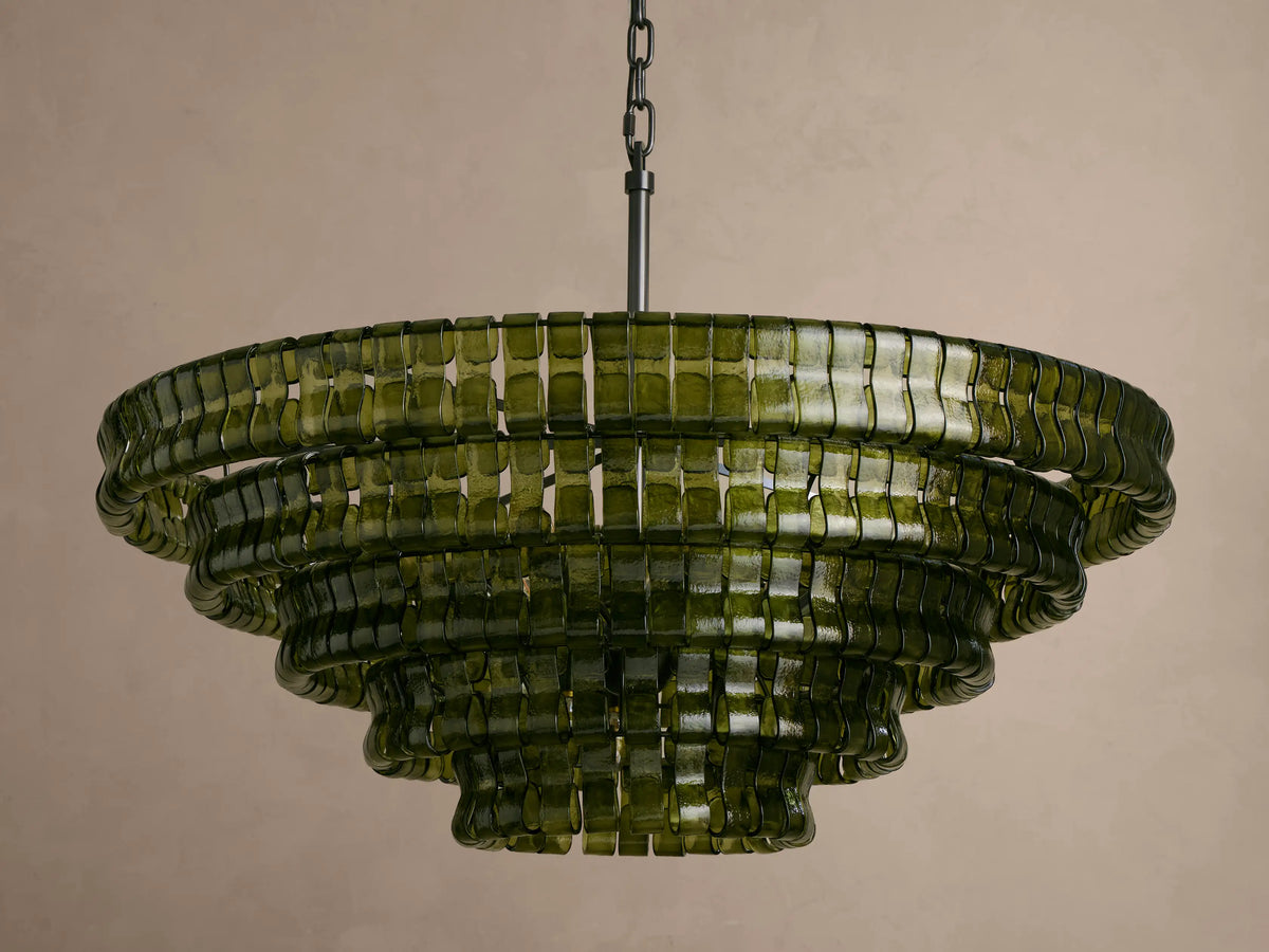 Ghiaccio Round Chandelier: multi-tiered, dark olive curved glass, glowing warmly from internal lights, suspended.