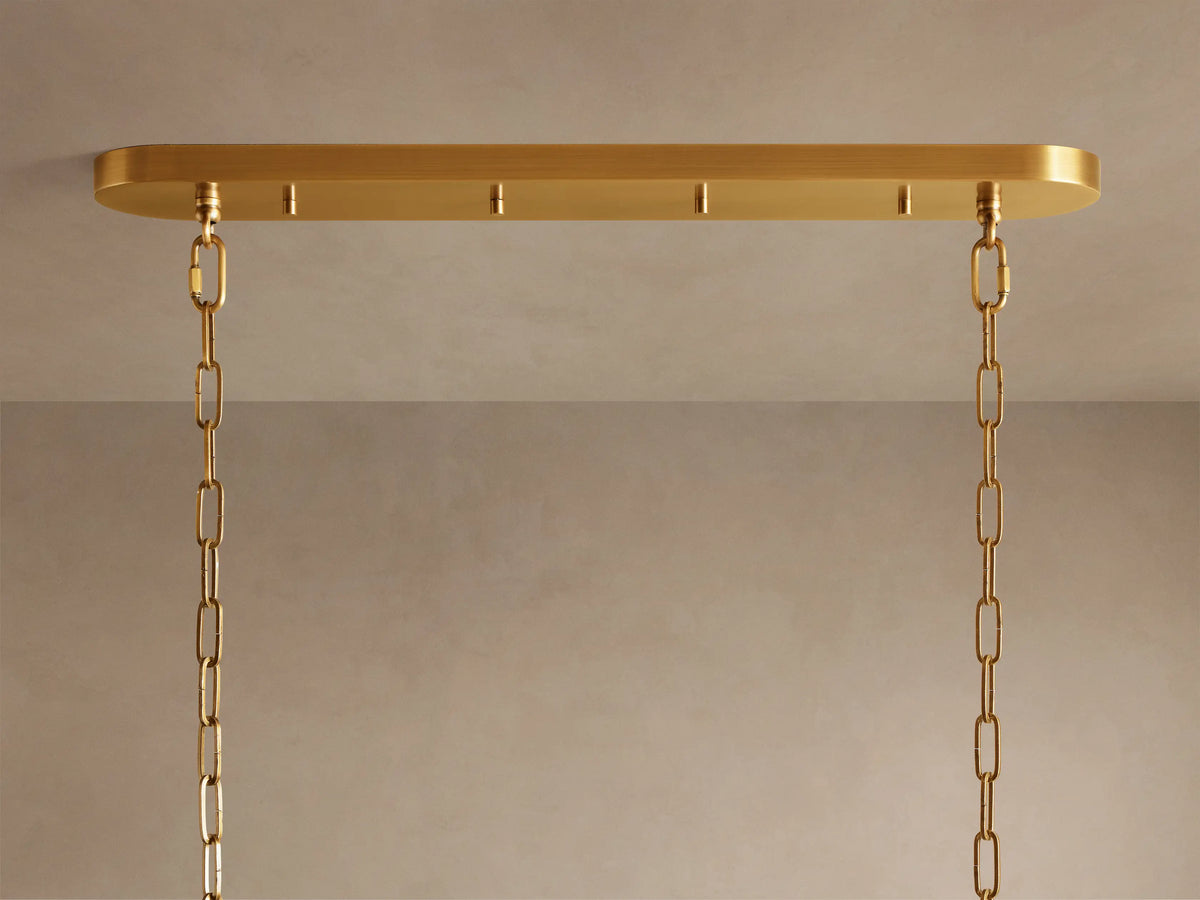 Close-up of Ghiaccio Oval Chandelier, showing rows of glowing, curved olive-green glass panels diffusing warm light.