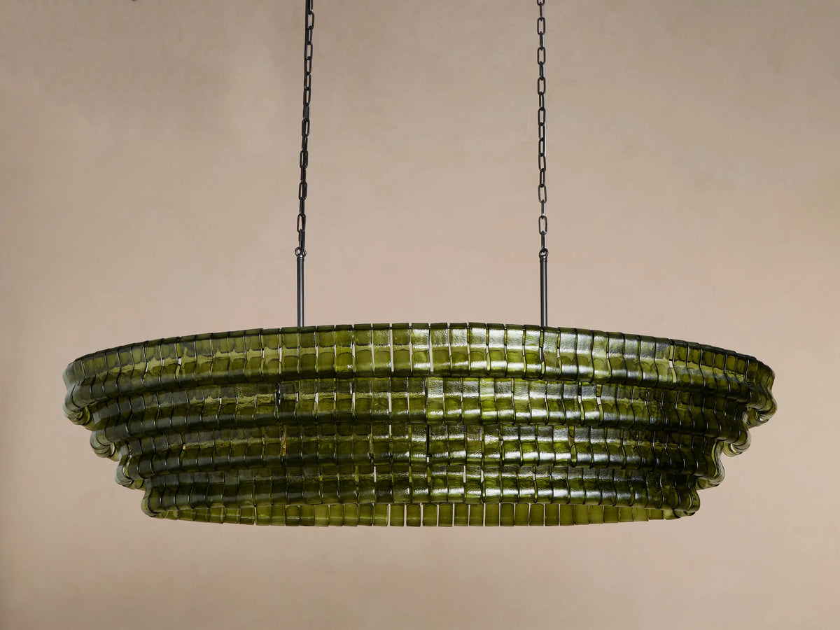 Ghiaccio Oval Chandelier: tiered, olive green curved glass blocks with warm internal glow, suspended by dark chains.