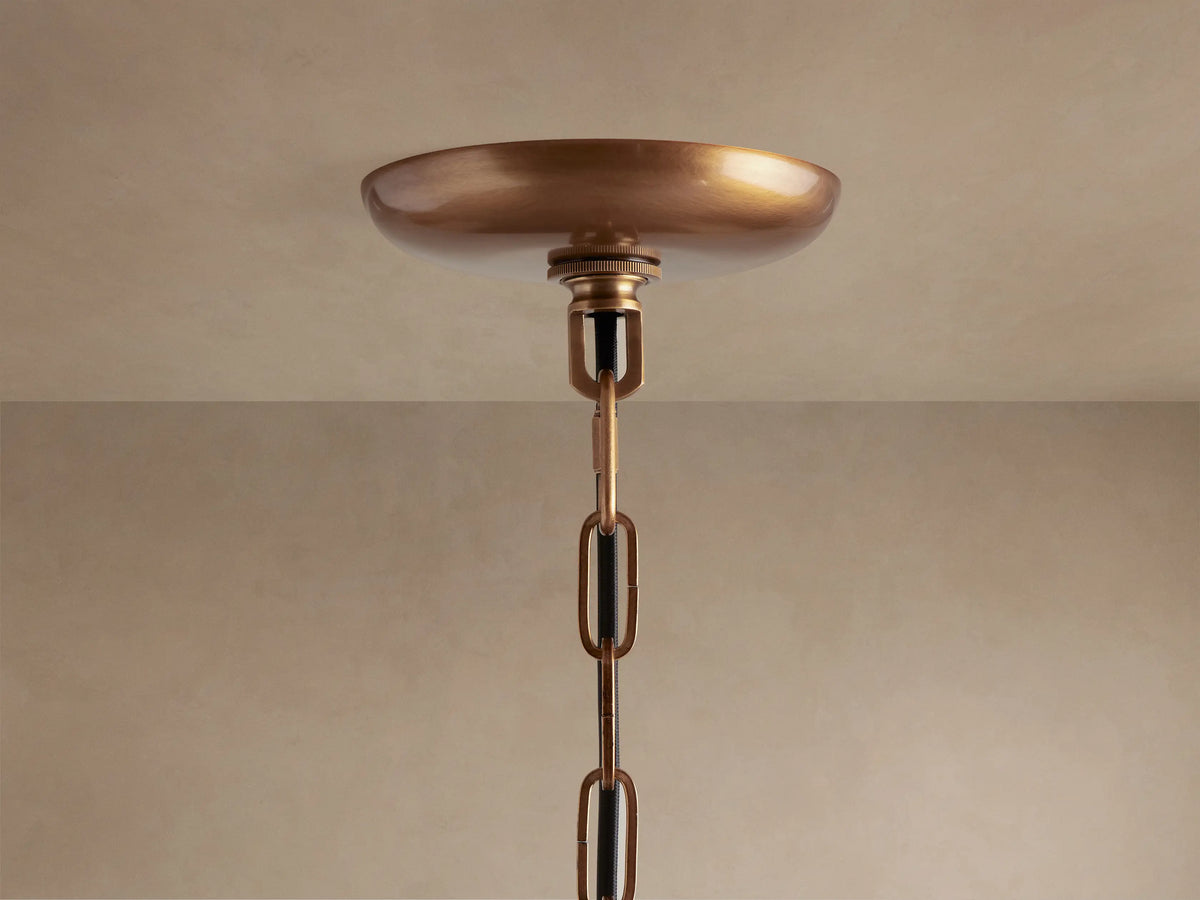 Close-up of Ghiaccio Pendant with textured, olive green curved glass pieces glowing warmly from internal light source.