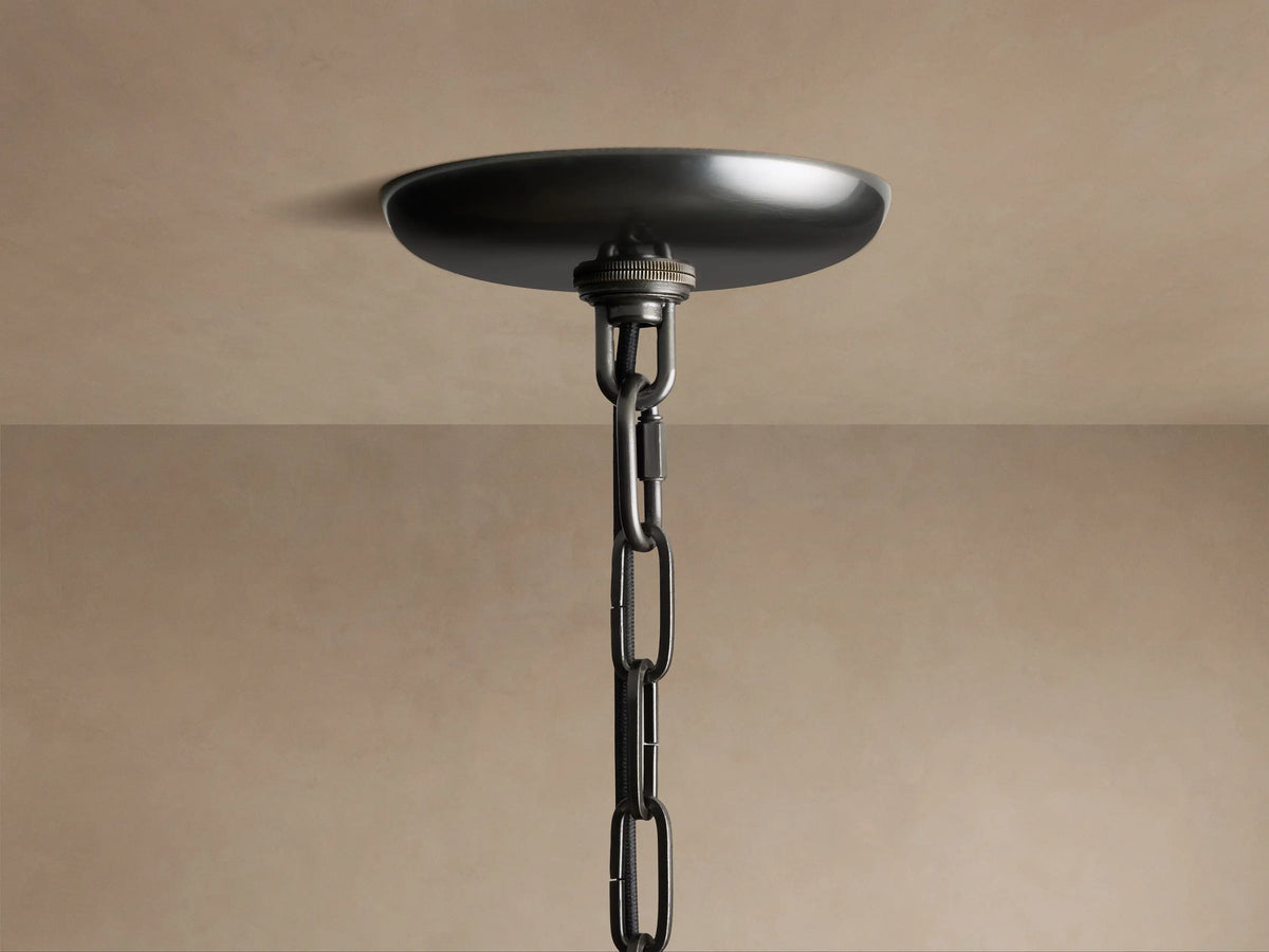 Close-up of Ghiaccio Pendant, featuring curved, textured amber-green glass panels glowing brightly from within.