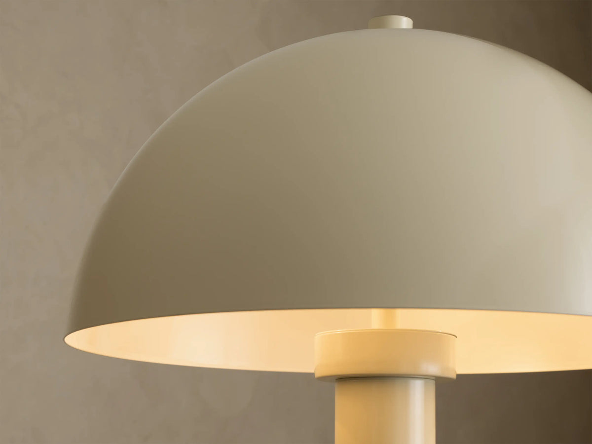 Front view of a Cream floor lamp with a dome-shaped shade, long slim body, and a round flat base.