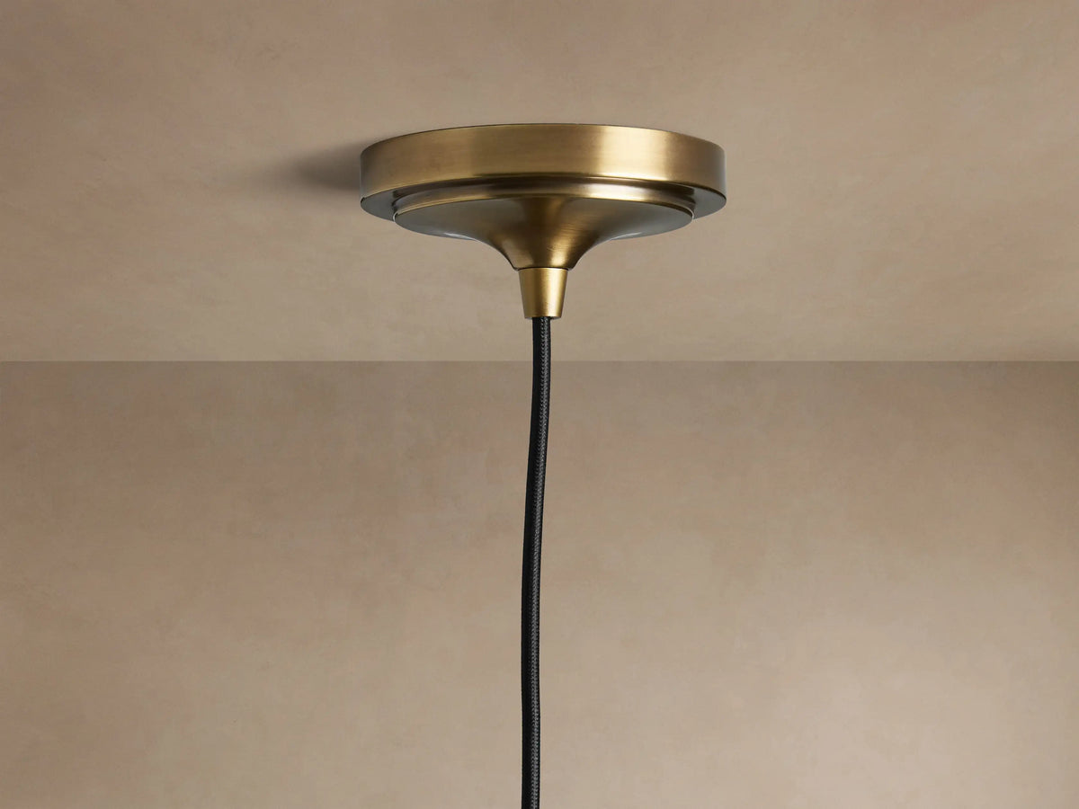 Close-up of Recycled Metal Fan Pendant: brass socket, dark hammered metal shade, delicate butterfly engraving.