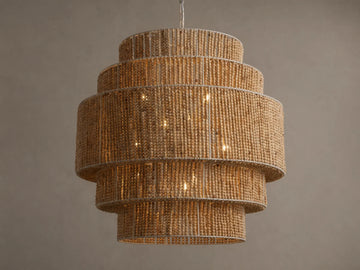 Kash Chandelier, a layered, cylindrical light fixture made of natural wooden beads, with warm internal lights glowing.