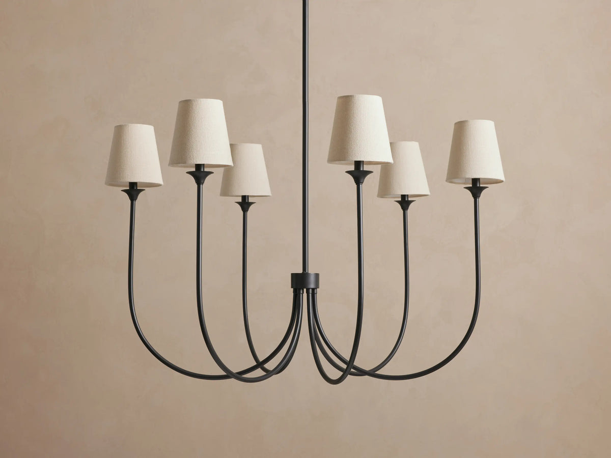 Saige Round Chandelier. Bronze-finished metal chandelier with six downward curving arms, each topped with an off-white shade.