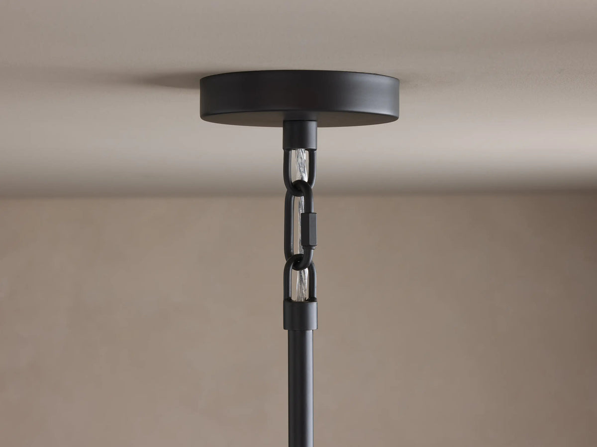 Saige Round Chandelier close-up: black ceiling canopy, black chain, and hanging rod against a light ceiling.