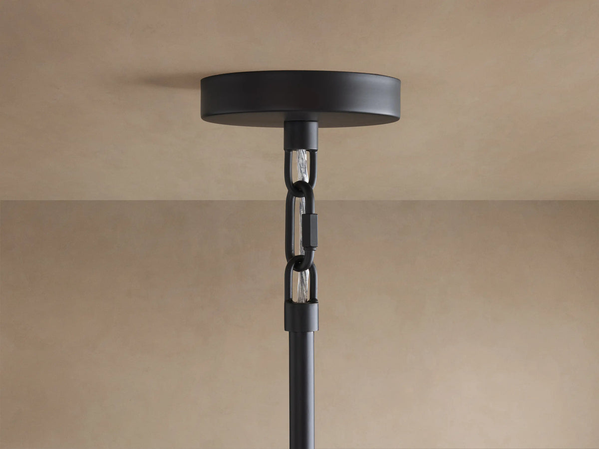 Saige Round Chandelier ceiling mount: black metal round plate, black hanging rod with internal silver-toned chain, on a beige ceiling.